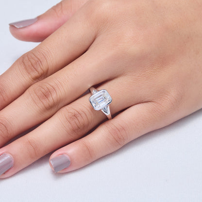 9x7mm Emerald Cut Moissanite Engagement Ring: Silver Bezel Split Shank Design