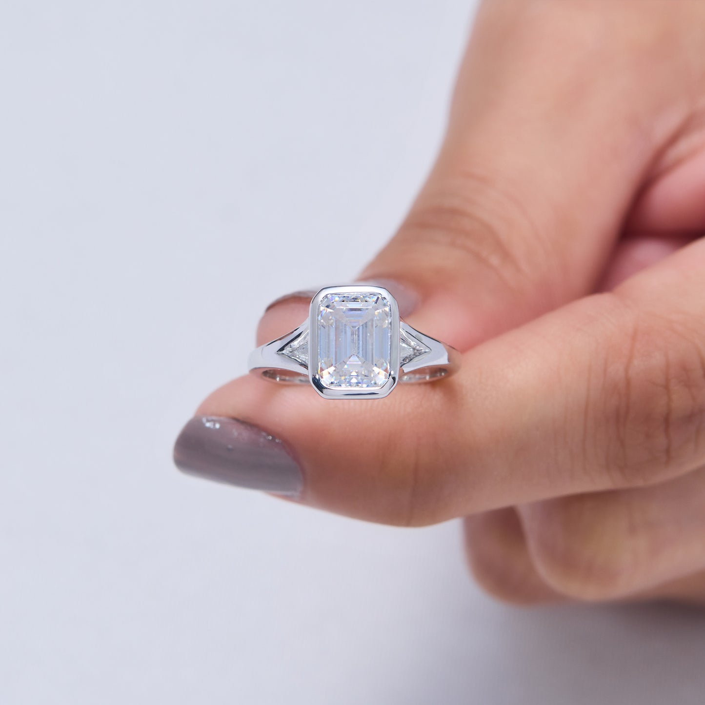 9x7mm Emerald Cut Moissanite Engagement Ring: Silver Bezel Split Shank Design