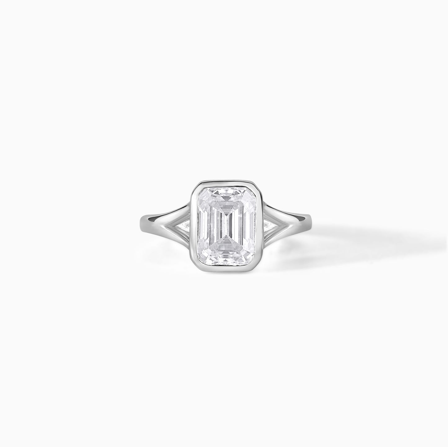 9x7mm Emerald Cut Moissanite Engagement Ring: Silver Bezel Split Shank Design
