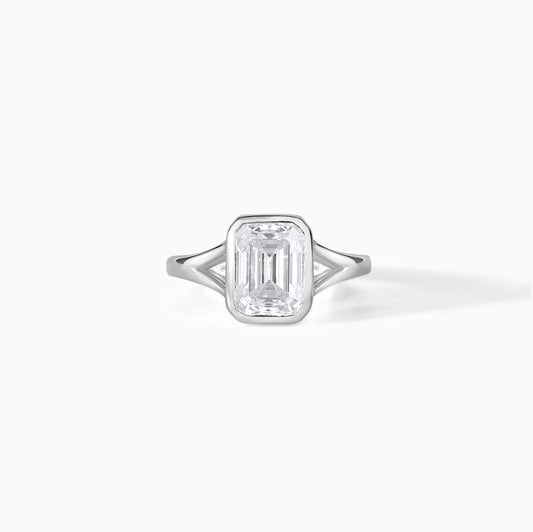 9x7mm Emerald Cut Moissanite Engagement Ring: Silver Bezel Split Shank Design
