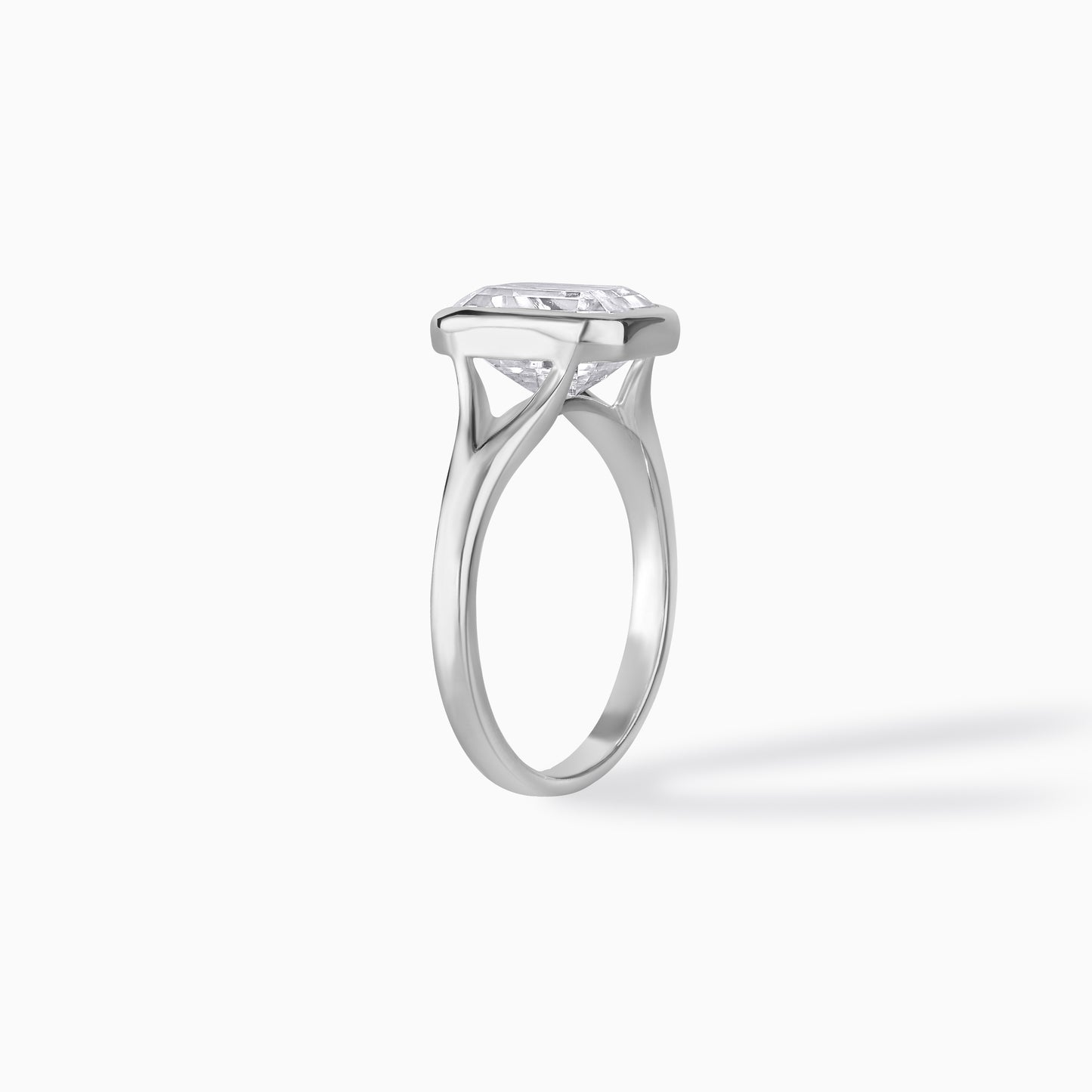 9x7mm Emerald Cut Moissanite Engagement Ring: Silver Bezel Split Shank Design