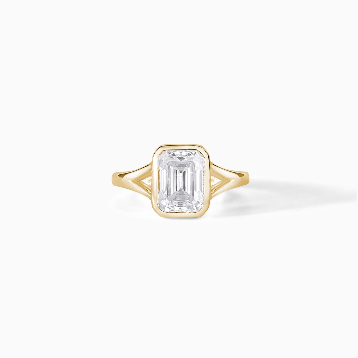 9x7mm Emerald Cut Moissanite Engagement Ring: Silver Bezel Split Shank Design