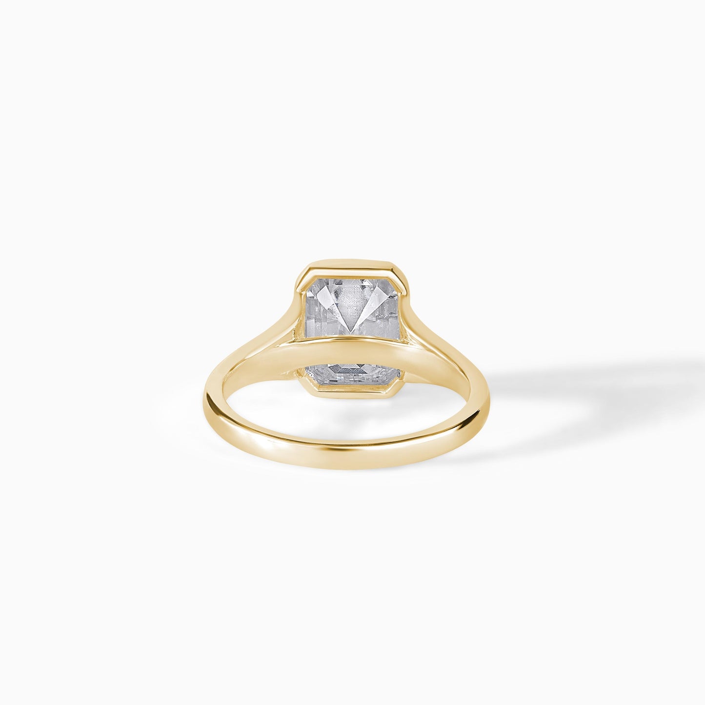 9x7mm Emerald Cut Moissanite Engagement Ring: Silver Bezel Split Shank Design