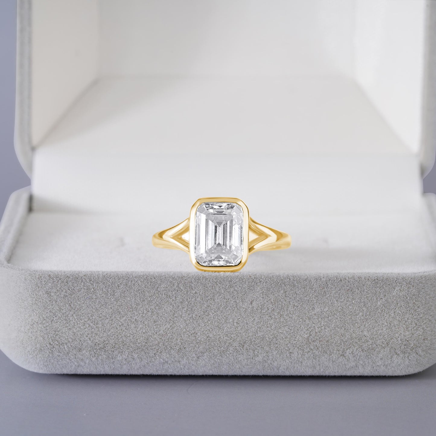 9x7mm Emerald Cut Moissanite Engagement Ring: Silver Bezel Split Shank Design
