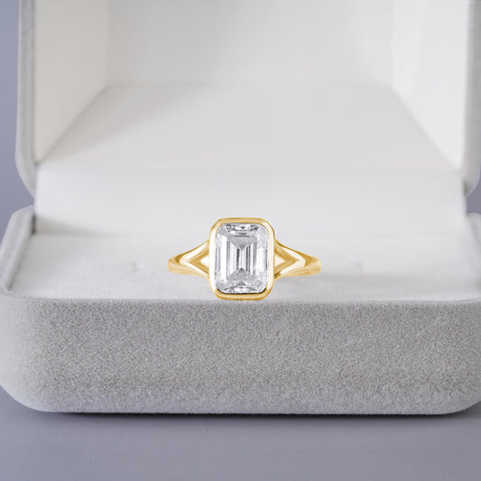 9x7mm Emerald Cut Moissanite Engagement Ring: Silver Bezel Split Shank Design